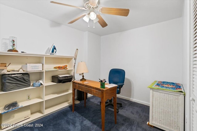 office space with dark carpet, baseboards, and ceiling fan