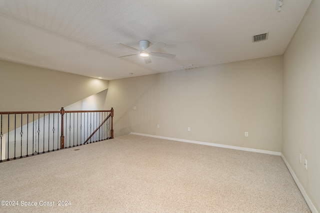 empty room with ceiling fan, a textured ceiling, and carpet floors