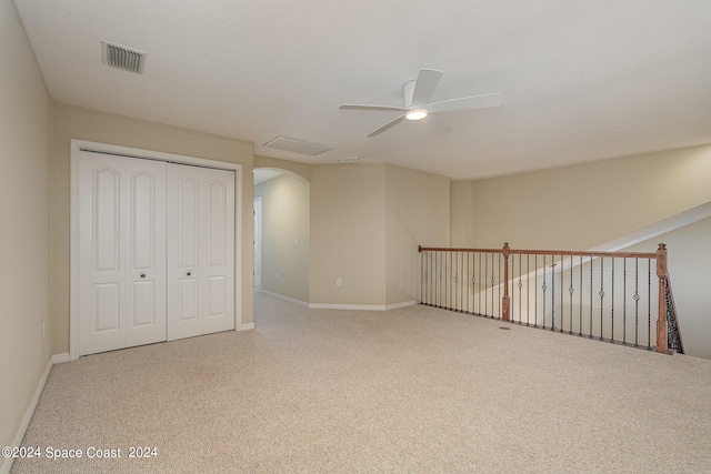 interior space featuring a textured ceiling, carpet, a closet, and ceiling fan