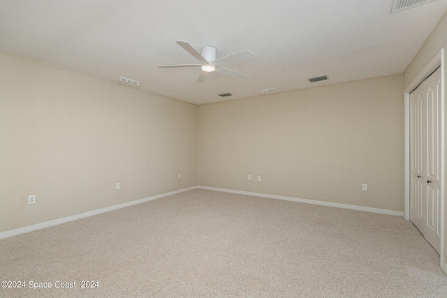 interior space featuring light carpet and ceiling fan