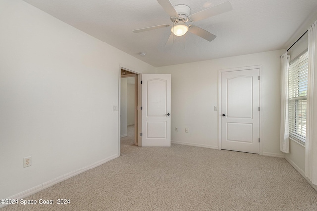 unfurnished bedroom with light carpet and ceiling fan