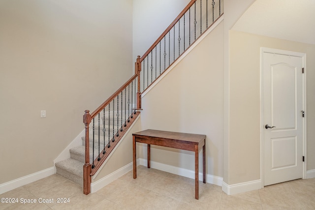 staircase with tile patterned floors