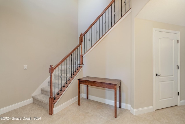 stairs with tile patterned floors