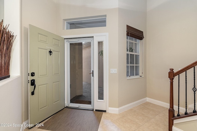 tiled entrance foyer with a high ceiling