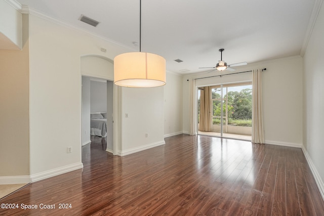 spare room featuring ceiling fan, ornamental molding, and wood-type flooring