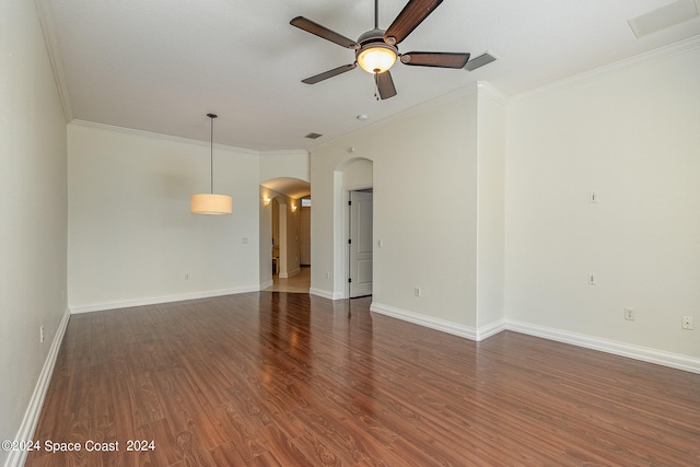 empty room with ceiling fan, crown molding, and wood-type flooring