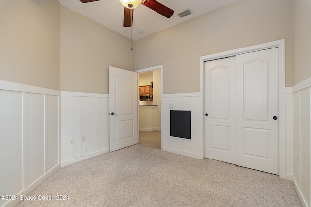 unfurnished bedroom with ceiling fan and light carpet