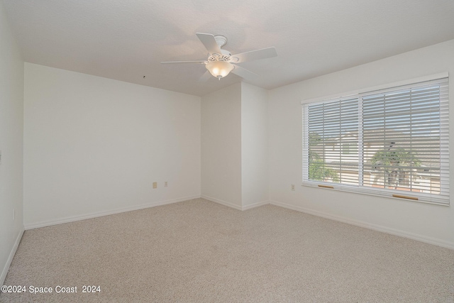 unfurnished room featuring ceiling fan, carpet flooring, and a textured ceiling