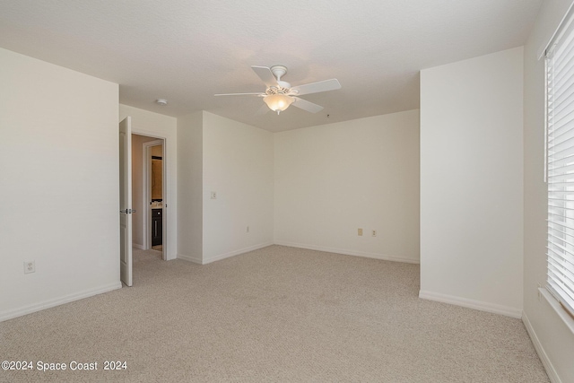 unfurnished bedroom with ceiling fan and light colored carpet