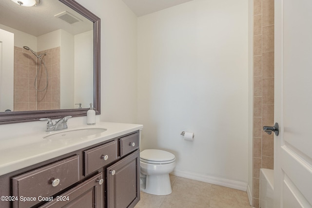 full bathroom with tile patterned floors, vanity, tiled shower / bath combo, and toilet