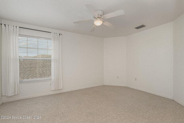 empty room featuring carpet and ceiling fan