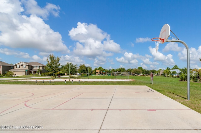 view of sport court with volleyball court and a lawn