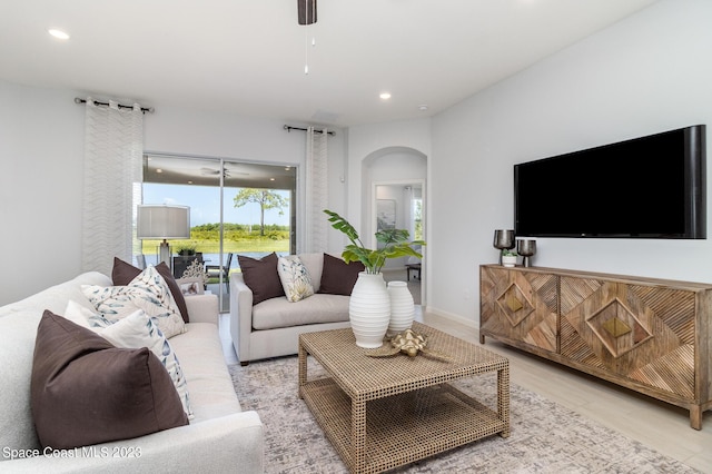 living room with ceiling fan and light wood-type flooring