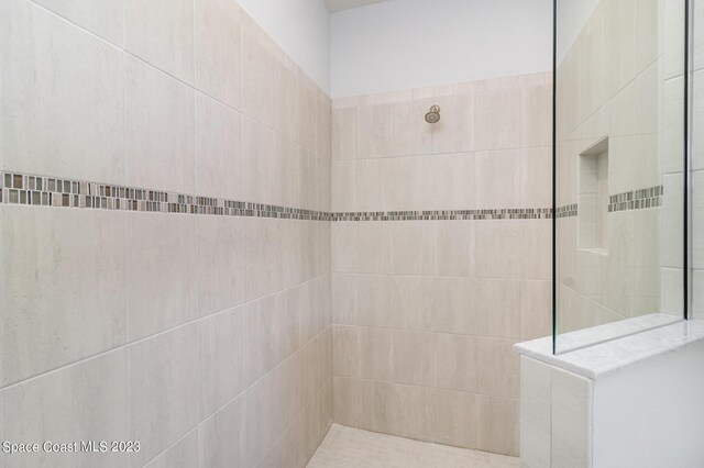 bathroom with a tile shower