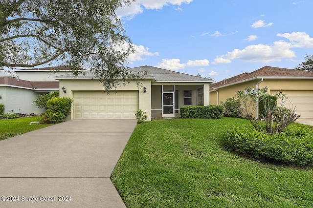 ranch-style home featuring a front lawn and a garage