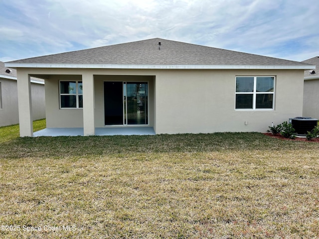 back of house featuring a lawn, a patio, and central air condition unit