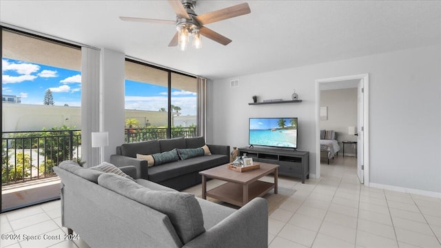 tiled living room with ceiling fan and a wealth of natural light