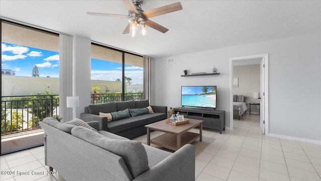 living room featuring light tile patterned floors, baseboards, visible vents, and a ceiling fan