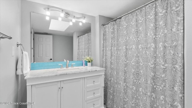 bathroom with vanity and a skylight