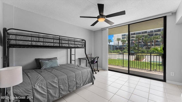 bedroom featuring ceiling fan, access to exterior, a textured ceiling, and light tile patterned floors