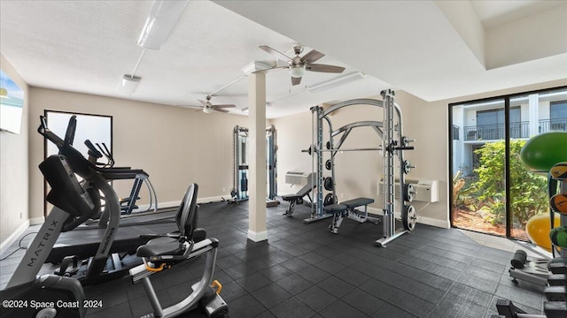 workout area with ceiling fan, a textured ceiling, and plenty of natural light