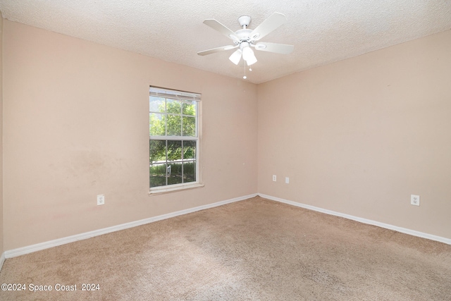 unfurnished room with ceiling fan, a textured ceiling, and carpet flooring