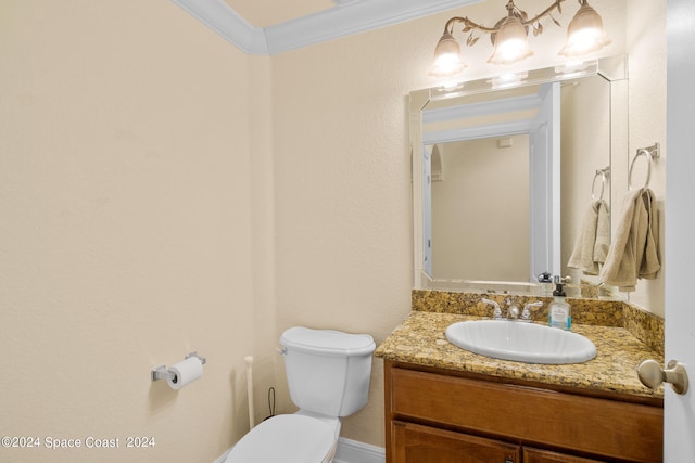 bathroom with vanity, toilet, and crown molding