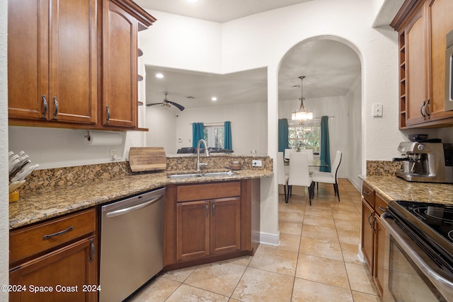 kitchen with light tile patterned floors, ceiling fan, sink, stainless steel dishwasher, and stone counters