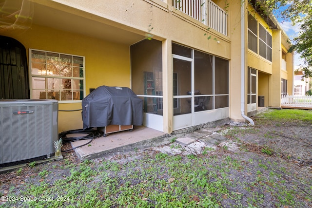 exterior space featuring central AC and a balcony