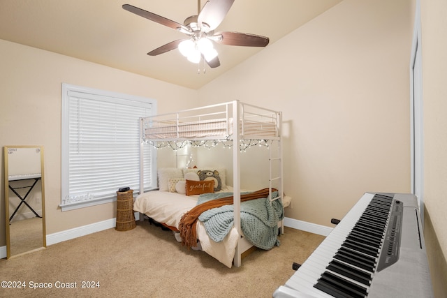 carpeted bedroom with ceiling fan and vaulted ceiling