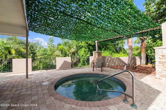 view of pool featuring an in ground hot tub and a patio area