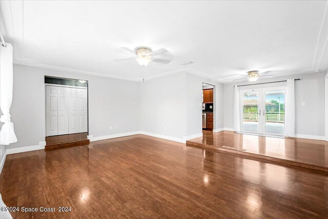 unfurnished living room featuring hardwood / wood-style floors, french doors, crown molding, and ceiling fan