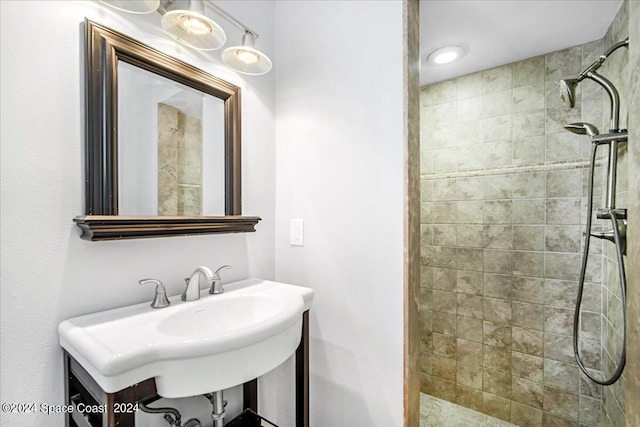 bathroom featuring sink and a tile shower