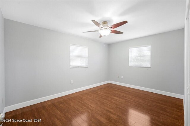 empty room featuring ceiling fan and hardwood / wood-style floors