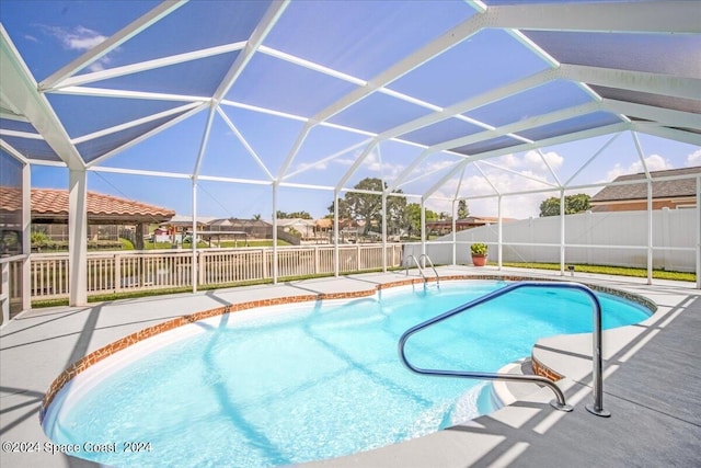 view of swimming pool with glass enclosure