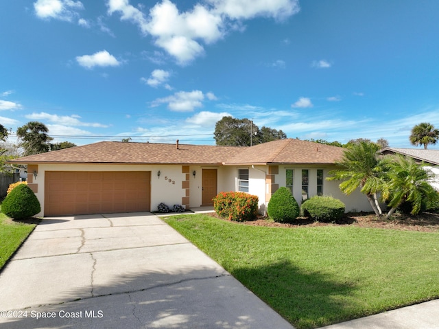 ranch-style house with a garage and a front lawn