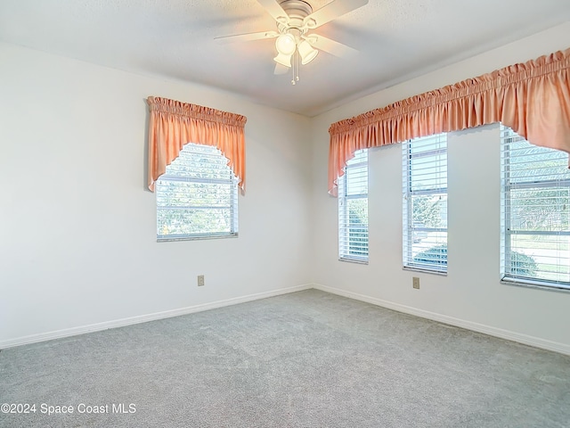 empty room with carpet flooring and ceiling fan