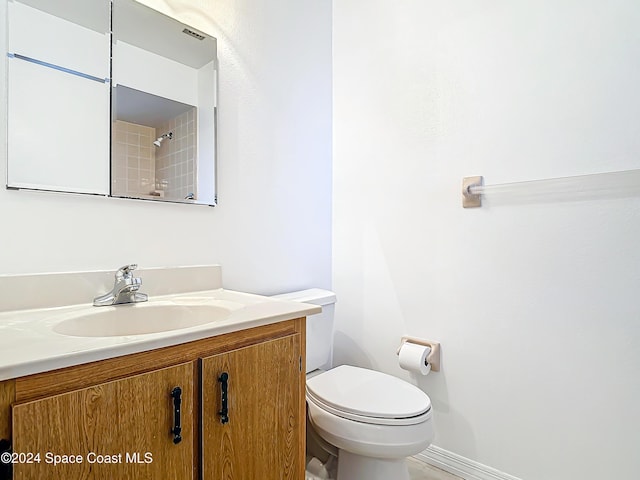 bathroom featuring vanity and toilet