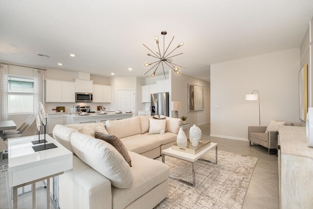 tiled living room with a chandelier