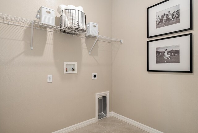 washroom with electric dryer hookup, light tile patterned floors, and washer hookup