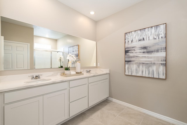 bathroom with tile patterned flooring, vanity, and a shower with door