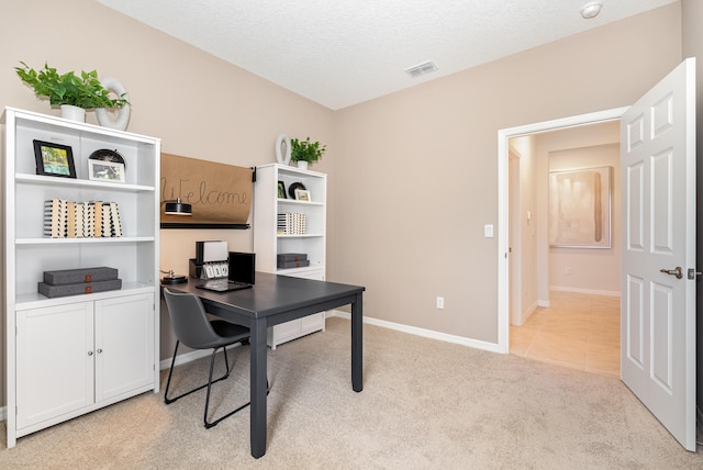 office space with light colored carpet and a textured ceiling