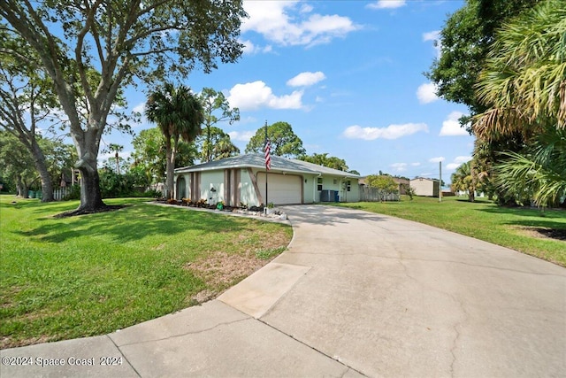 single story home with a garage, driveway, and a front yard