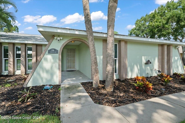 doorway to property with stucco siding