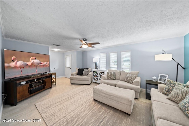 living room featuring light wood finished floors, visible vents, ornamental molding, ceiling fan, and a textured ceiling