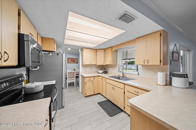 kitchen featuring black / electric stove, a sink, visible vents, light countertops, and light brown cabinetry