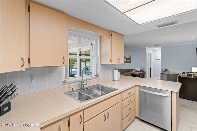 kitchen featuring a sink, a peninsula, light countertops, and dishwasher