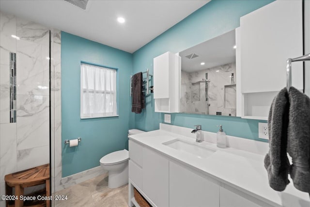 bathroom featuring a marble finish shower, visible vents, toilet, vanity, and baseboards