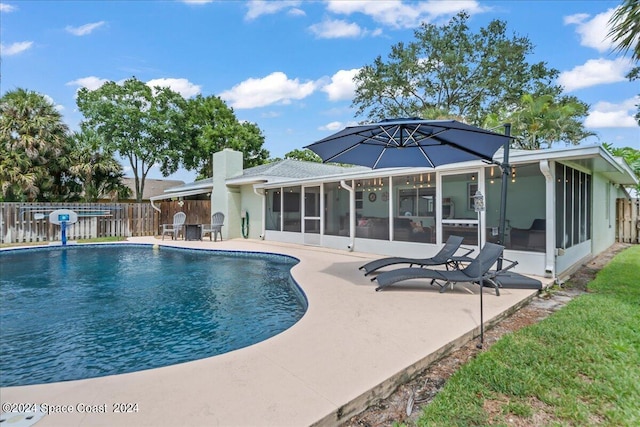 view of pool with a patio, fence, a sunroom, and a fenced in pool