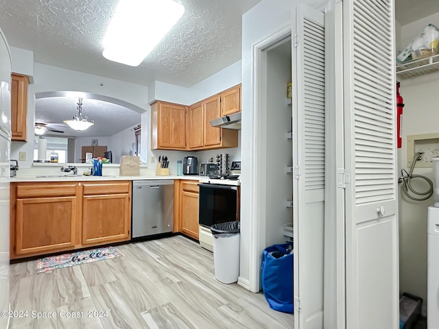 kitchen featuring pendant lighting, white range with electric stovetop, stainless steel dishwasher, a textured ceiling, and light hardwood / wood-style flooring